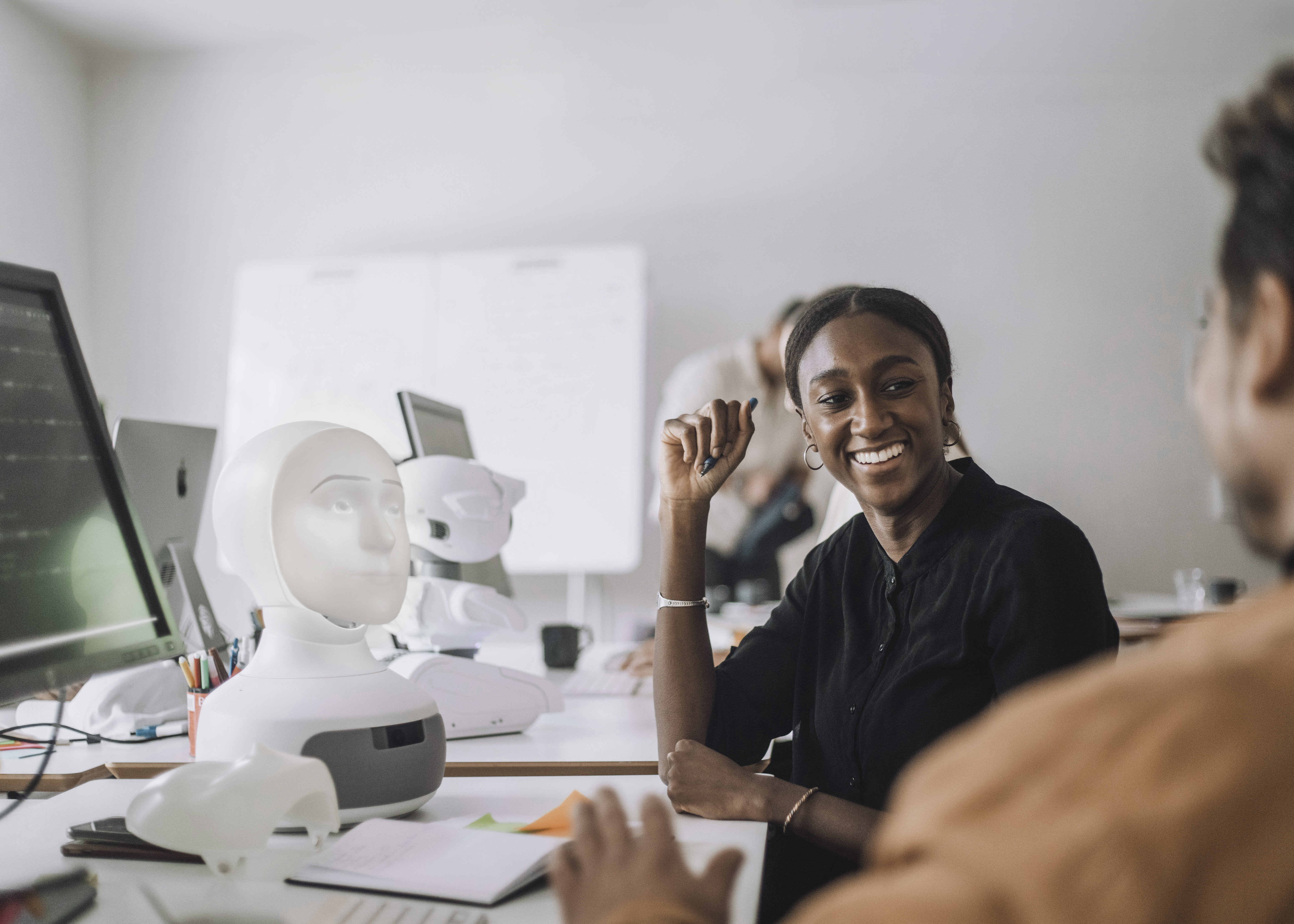 Colleagues talking at desk