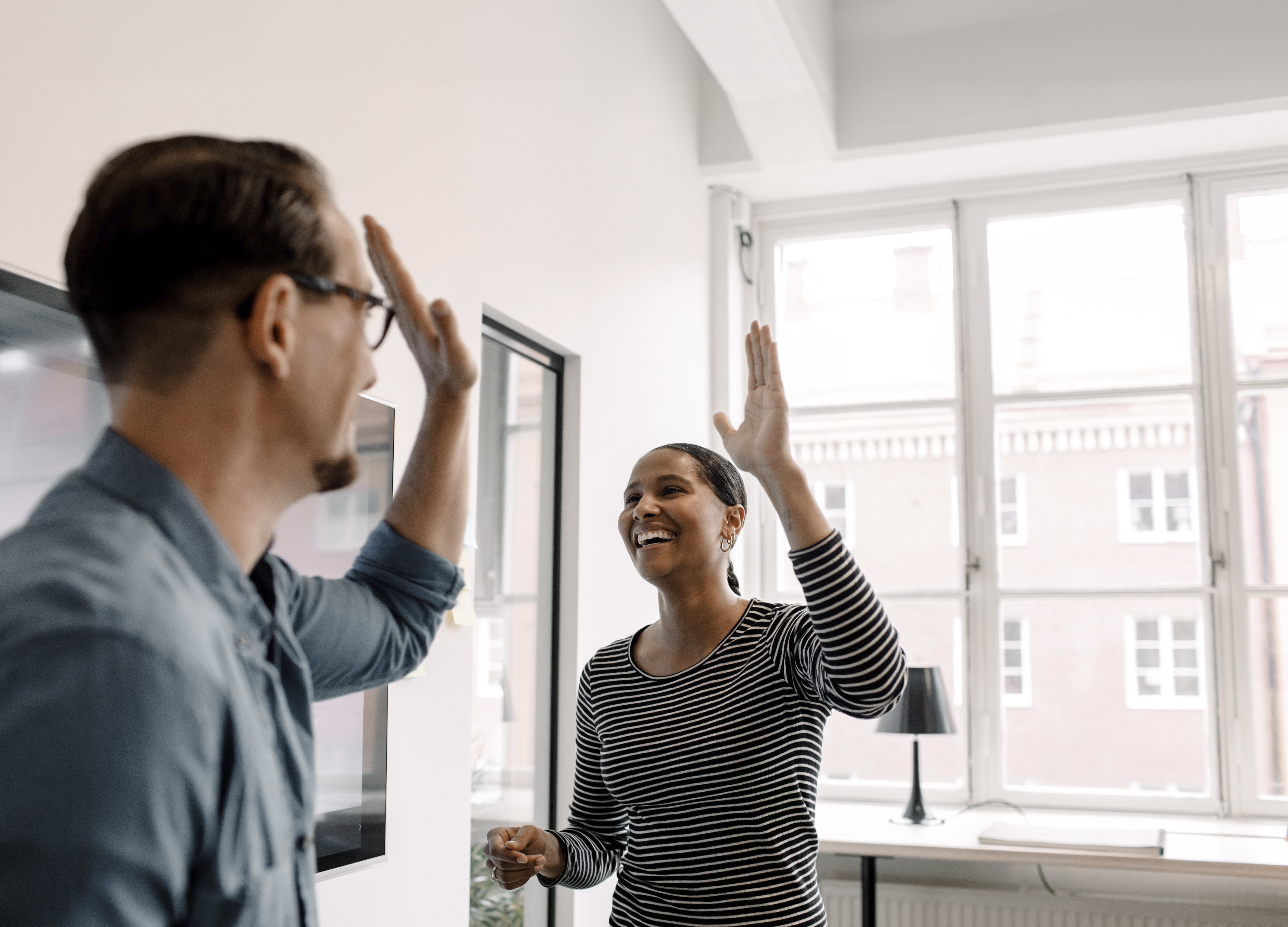 Colleagues high-fiving each other